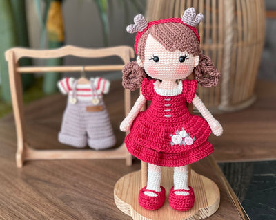 Handmade crochet Forest Girl Doll with two interchangeable dresses and matching accessories. This amigurumi doll is customizable with a name on a leather label, perfect for personalized gifts.