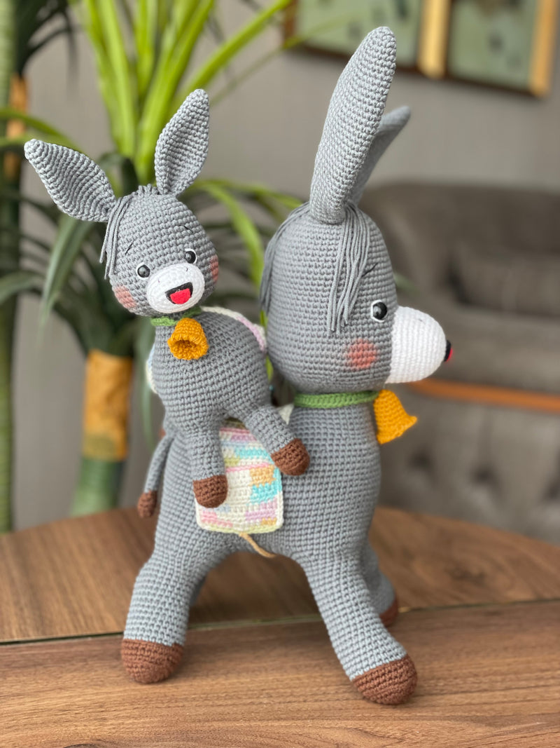 Handmade crochet Donkey Toy set, featuring a pair of amigurumi donkeys with detailed expressions, customized with a name on a leather label. Perfect gift for kids.