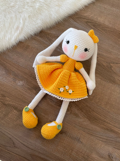 Handmade Yellow Dressed Bunny Rabbit Toy crocheted with amigurumi technique, featuring a cute yellow dress with embroidered flower details and customizable name on a leather label. Perfect for kids and baby gifts.