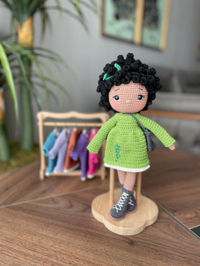 Handmade Rosemary dressed curly girl doll with a green outfit, crafted using amigurumi crochet technique, personalized with a name on a leather label, ideal for gifts.