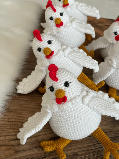 Handmade crocheted Chicken Toys with a cute and detailed design, featuring a red comb and yellow feet. This amigurumi toy is customizable with a name on a leather label, making it a perfect farm-themed nursery decor and personalized gift.