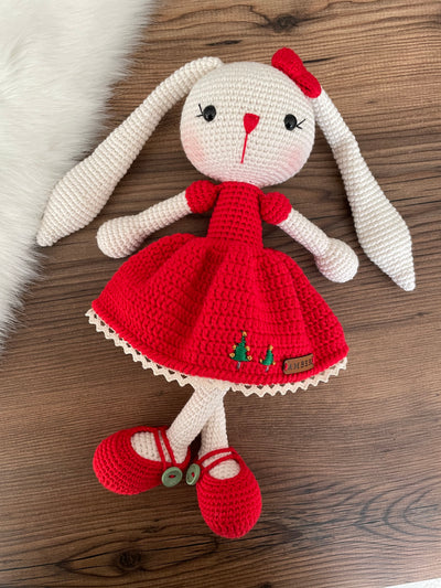 Handmade Red Dressed Bunny Rabbit Toy crocheted with amigurumi technique, featuring a cute red dress with embroidered christmas tree details and customizable name on a leather label. Perfect for kids and baby gifts.