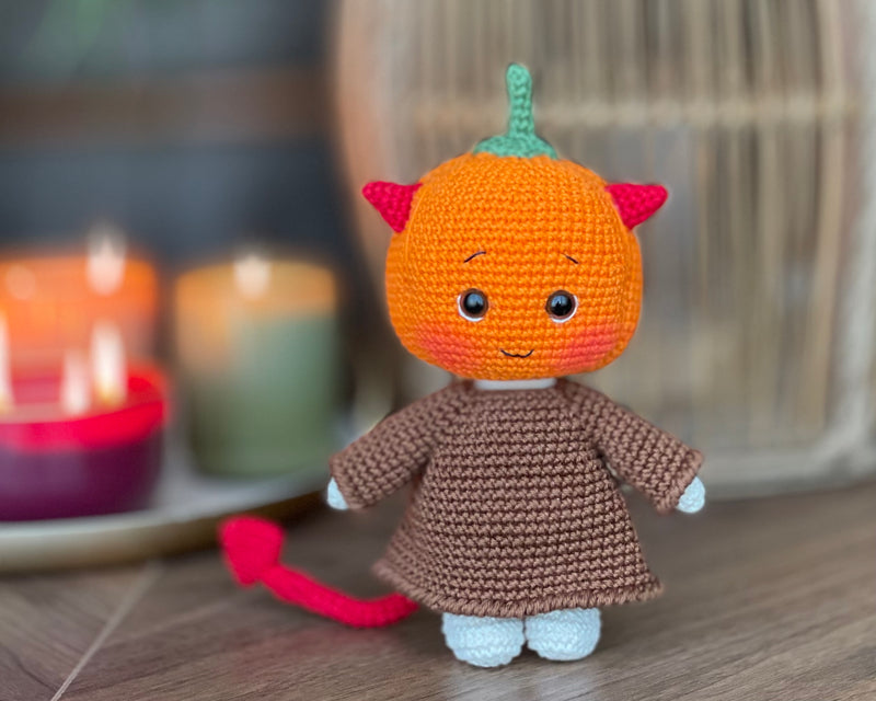 Handmade crocheted amigurumi toy named Pumpkin Monster Devil with a cute pumpkin head, devil horns, and a custom name option. Perfect for Halloween or spooky-themed gifts.