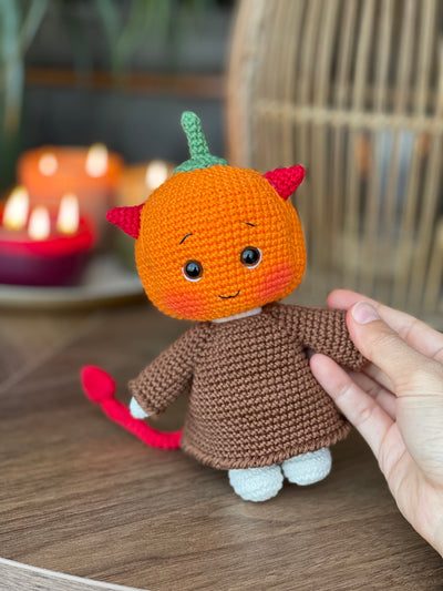 Handmade crocheted amigurumi toy named Pumpkin Monster Devil with a cute pumpkin head, devil horns, and a custom name option. Perfect for Halloween or spooky-themed gifts.