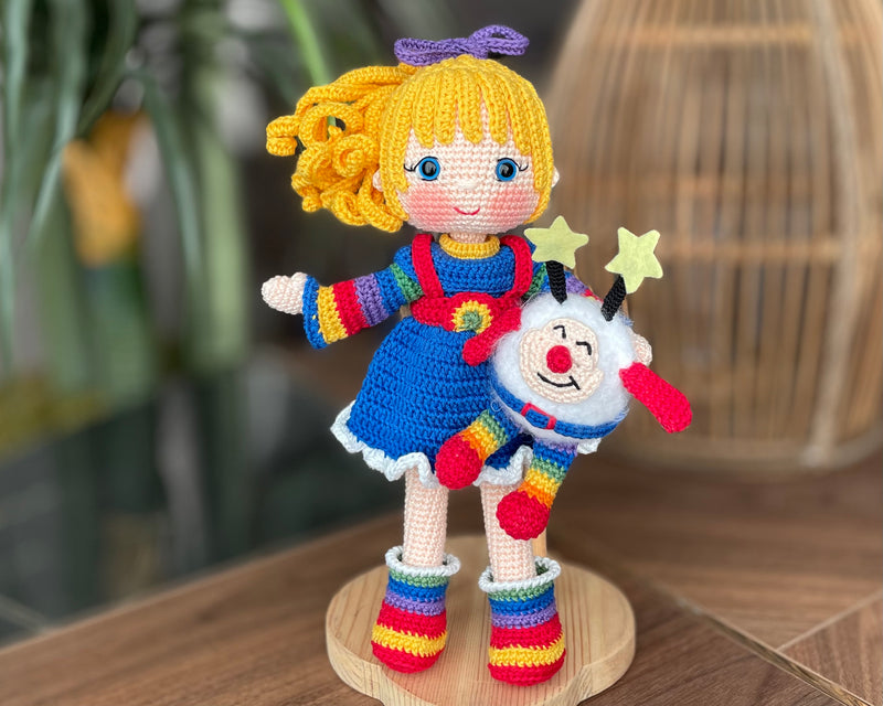 A handmade Rainbow Brite Girl Doll with vibrant yellow hair, holding Twink, a colorful star plush toy and personalized with a custom name on a leather label, perfect gift for children and collectors.