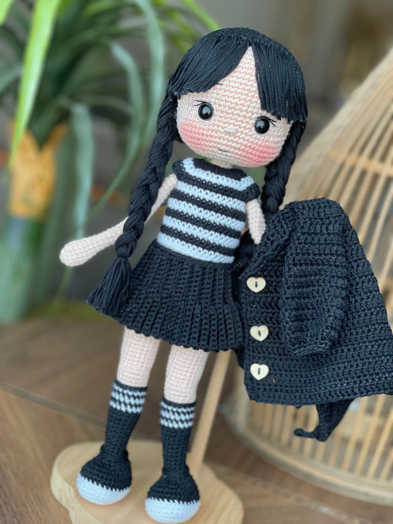 Handmade Wednesday Addams Doll with black braids, a black dress, and a spooky themed accessory, crocheted using the amigurumi technique and personalized with a name. Perfect for kids and Halloween Gift.