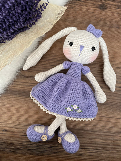 Handmade crochet Lilac Dressed Bunny Rabbit Toy, featuring long ears, a lilac dress with floral details, and personalized with a name on a leather label. Perfect for gifting.