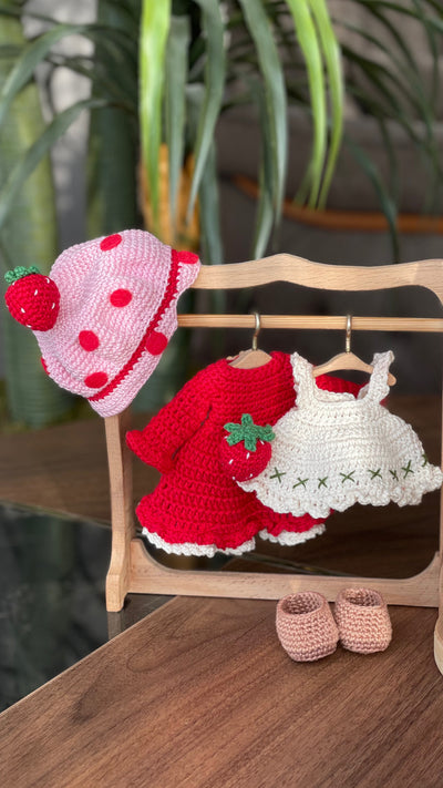 Handmade strawberry shortcake crochet doll with red hair, wearing a strawberry-themed outfit. Features a pink hat with red polka dots, red dress with white apron, and striped stockings. Perfect for children and collectors.