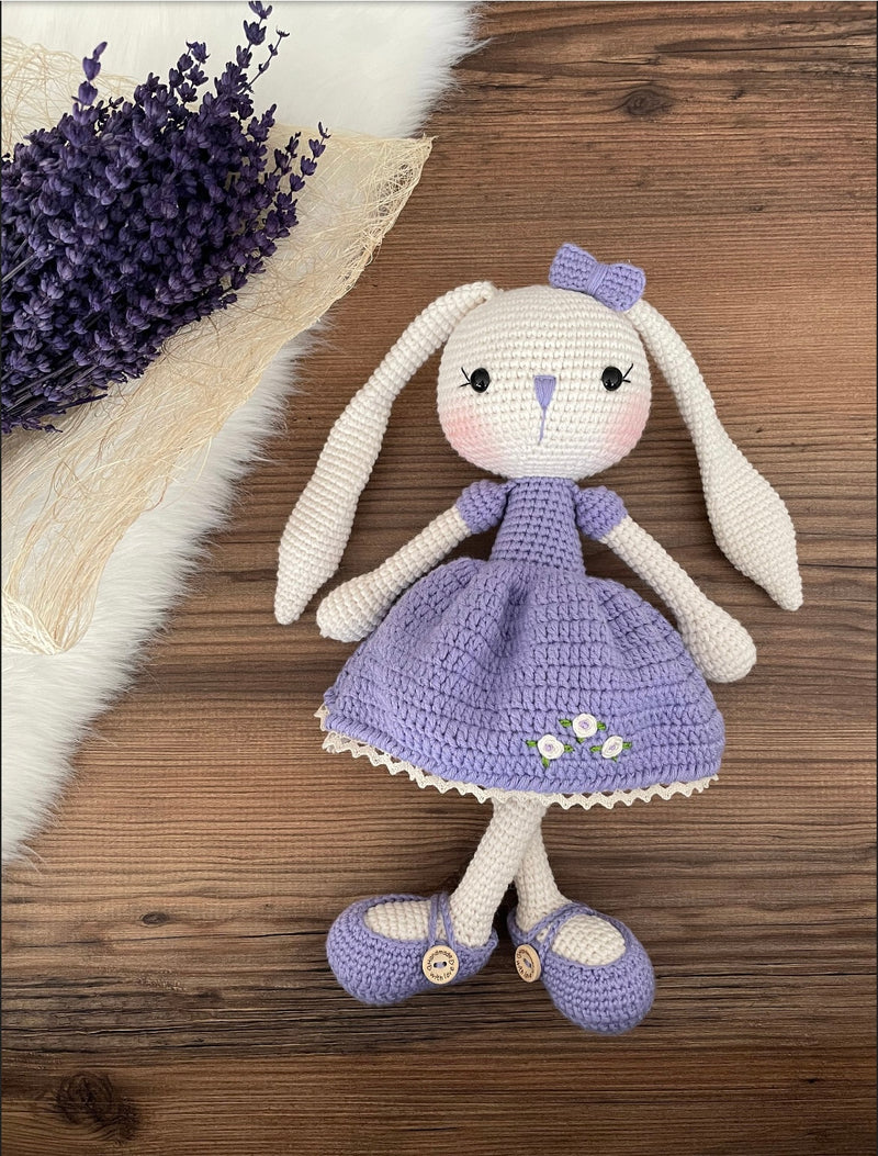 Handmade crochet Lilac Dressed Bunny Rabbit Toy, featuring long ears, a lilac dress with floral details, and personalized with a name on a leather label. Perfect for gifting.