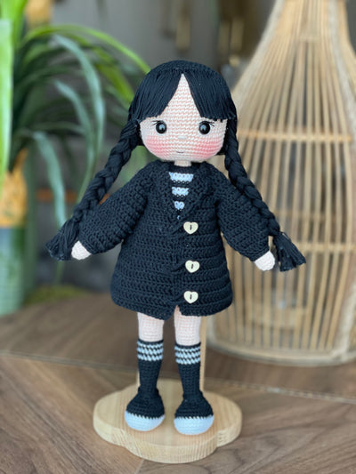 Handmade Wednesday Addams Doll with black braids, a black dress, and a spooky themed accessory, crocheted using the amigurumi technique and personalized with a name. Perfect for kids and Halloween Gift.