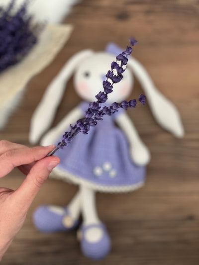 Handmade crochet Lilac Dressed Bunny Rabbit Toy, featuring long ears, a lilac dress with floral details, and personalized with a name on a leather label. Perfect for gifting.