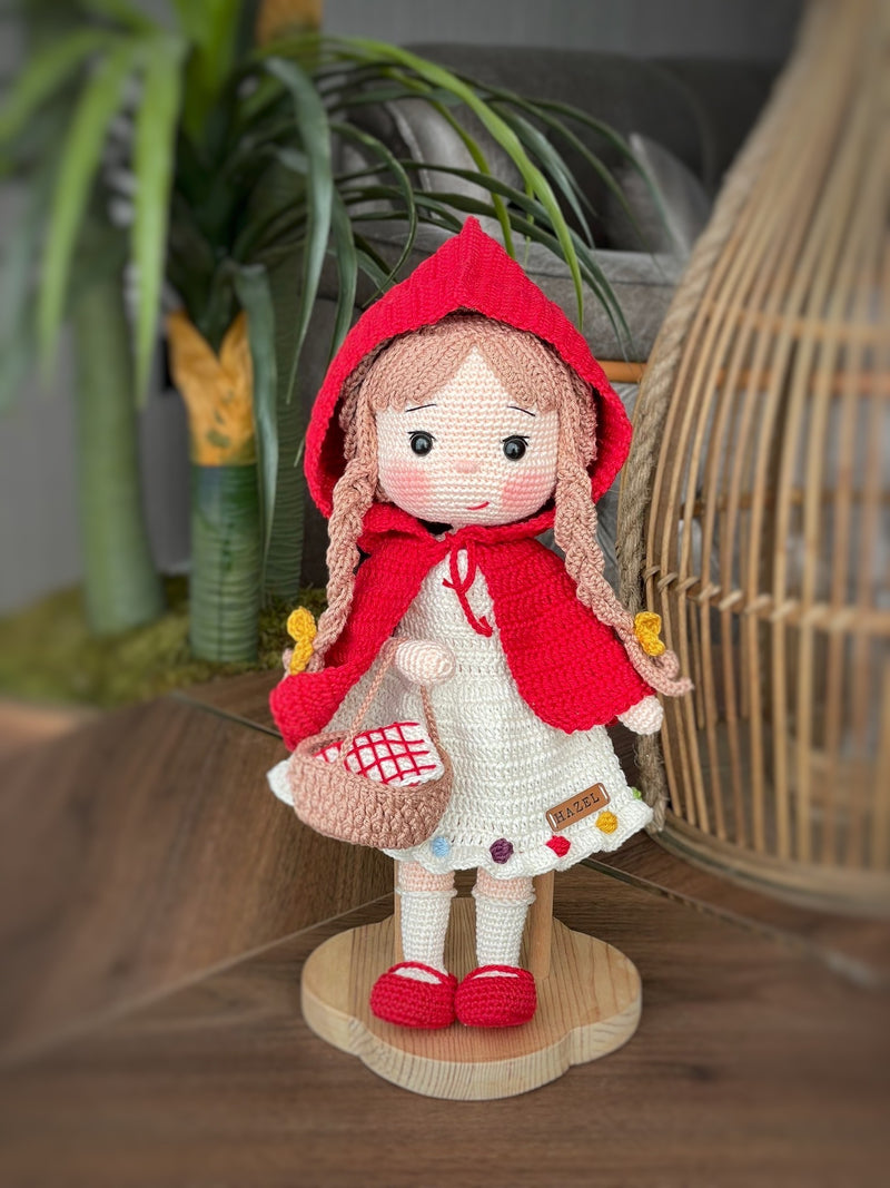 Handmade crochet Little Red Riding Hood doll, inspired by the classic fairytale, featuring a red cape, basket, and customizable name on a leather label. Perfect for kids and collectors.