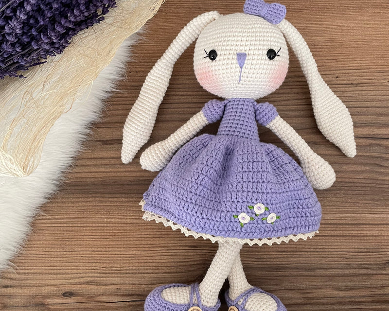 Handmade crochet Lilac Dressed Bunny Rabbit Toy, featuring long ears, a lilac dress with floral details, and personalized with a name on a leather label. Perfect for gifting.