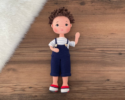 Handmade crocheted overall boy doll, crafted with amigurumi technique using 100% cotton yarn, customized with a name on a leather label, perfect gift.