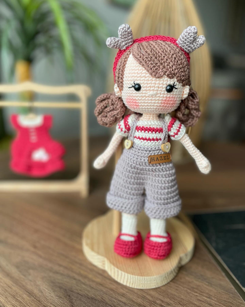 Handmade crochet Forest Girl Doll with two interchangeable dresses and matching accessories. This amigurumi doll is customizable with a name on a leather label, perfect for personalized gifts.