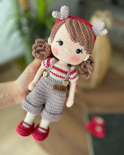 Handmade crochet Forest Girl Doll with two interchangeable dresses and matching accessories. This amigurumi doll is customizable with a name on a leather label, perfect for personalized gifts.