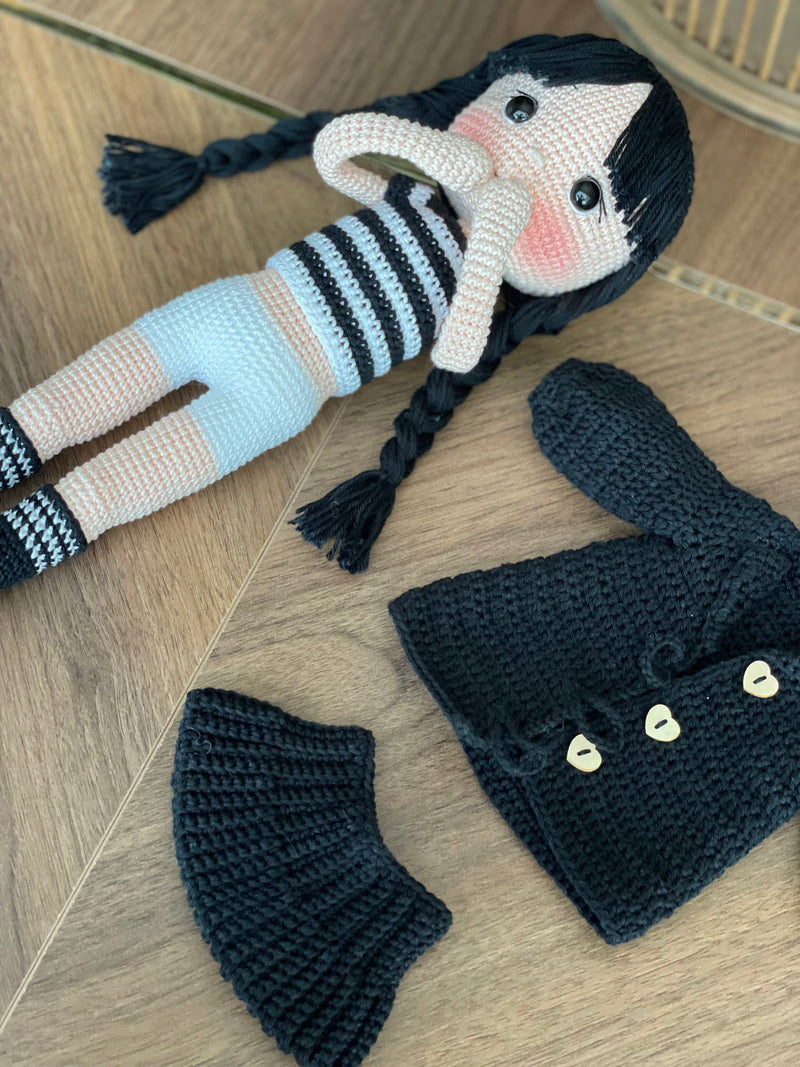 Handmade Wednesday Addams Doll with black braids, a black dress, and a spooky themed accessory, crocheted using the amigurumi technique and personalized with a name. Perfect for kids and Halloween Gift.