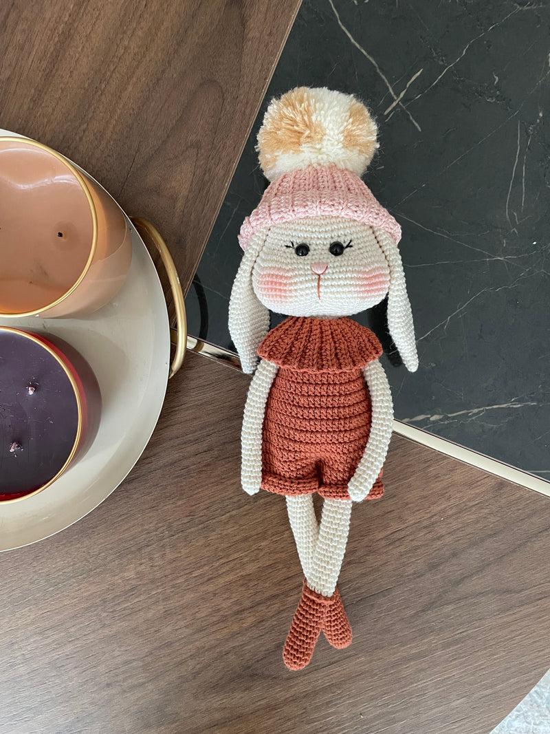 Handmade crocheted Hatted Bunny Rabbit Toy with a cozy hat and outfit, customizable with a name on a leather label. Perfect for nursery decor and as a unique easter or baby shower gift.