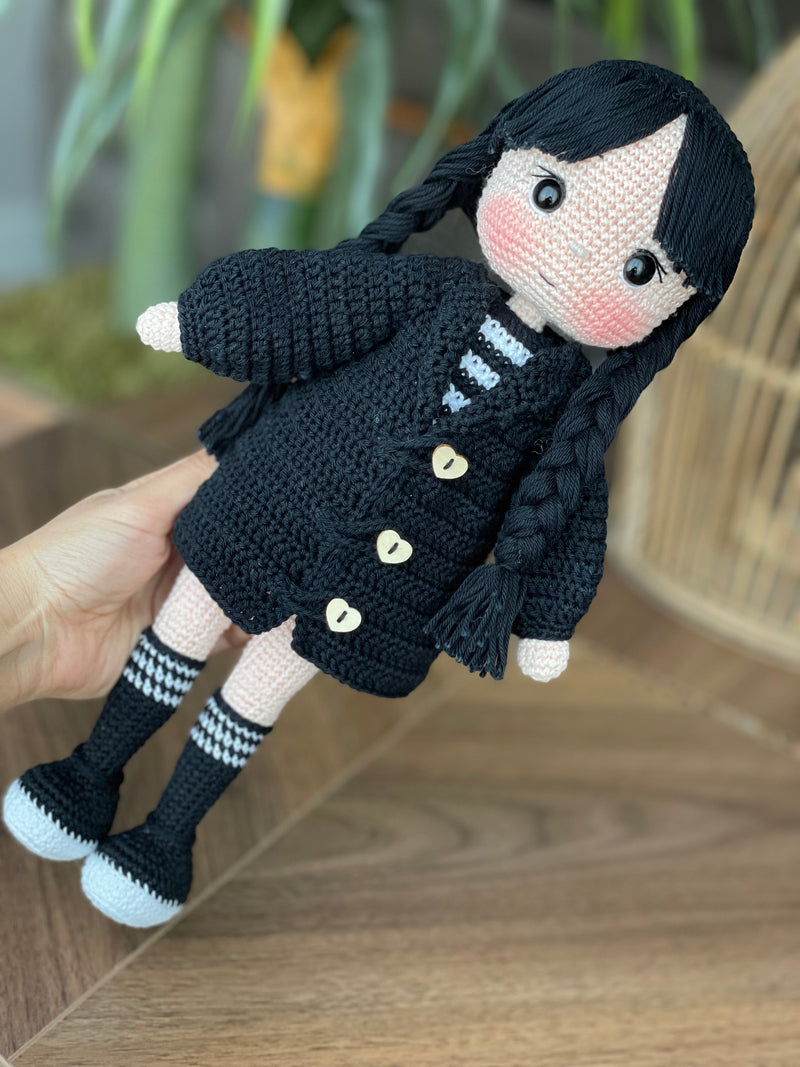 Handmade Wednesday Addams Doll with black braids, a black dress, and a spooky themed accessory, crocheted using the amigurumi technique and personalized with a name. Perfect for kids and Halloween Gift.