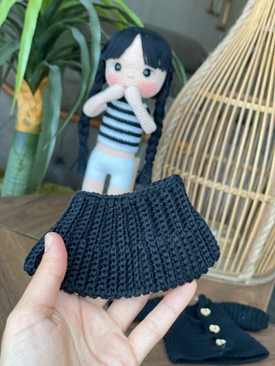 Handmade Wednesday Addams Doll with black braids, a black dress, and a spooky themed accessory, crocheted using the amigurumi technique and personalized with a name. Perfect for kids and Halloween Gift.