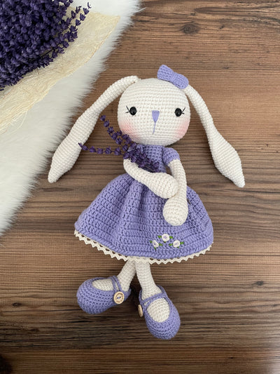 Handmade crochet Lilac Dressed Bunny Rabbit Toy, featuring long ears, a lilac dress with floral details, and personalized with a name on a leather label. Perfect for gifting.