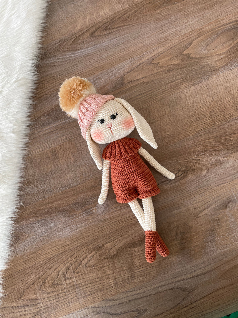 Handmade crocheted Hatted Bunny Rabbit Toy with a cozy hat and outfit, customizable with a name on a leather label. Perfect for nursery decor and as a unique easter or baby shower gift.