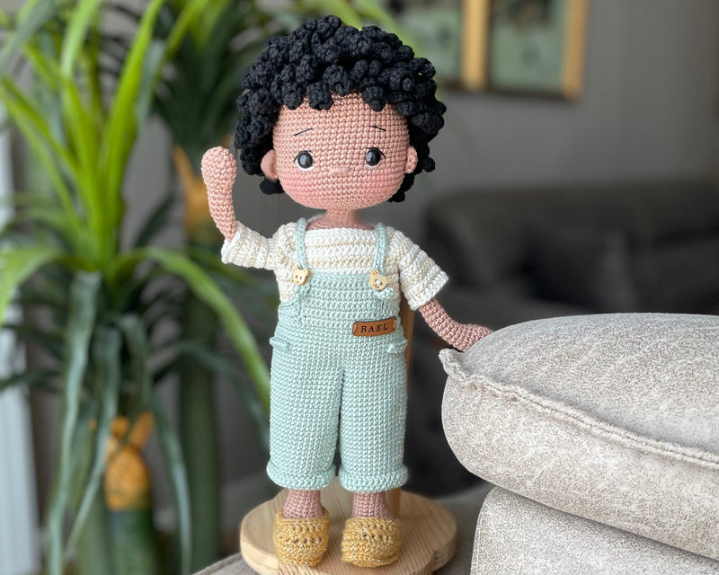 Handmade crocheted overall boy doll, crafted with amigurumi technique using 100% cotton yarn, customized with a name on a leather label, perfect gift.