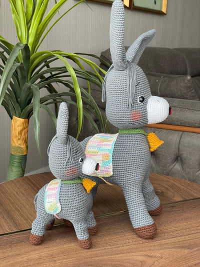 Handmade crochet Donkey Toy set, featuring a pair of amigurumi donkeys with detailed expressions, customized with a name on a leather label. Perfect gift for kids.