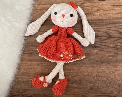 Handmade Brick Dressed Bunny Rabbit Toy crocheted with amigurumi technique, featuring a cute brick color dress with embroidered flower details and customizable name on a leather label. Perfect for kids and baby gifts.