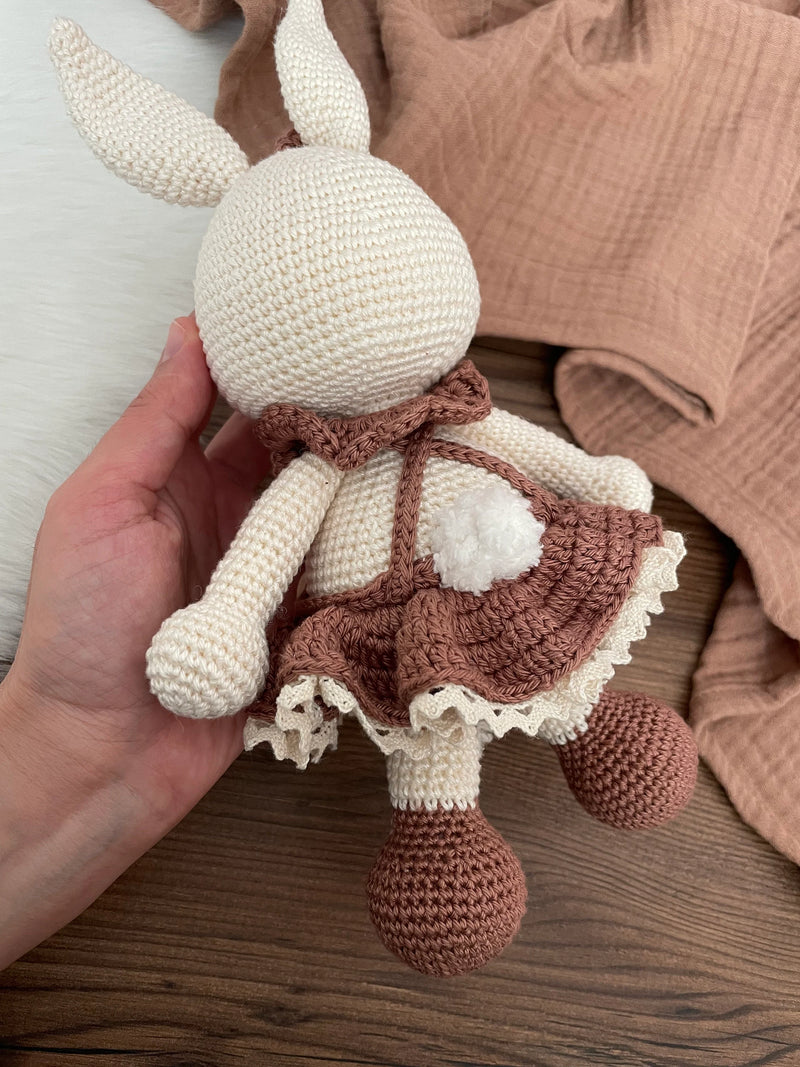 Handmade crocheted Chubby Girl Bunny Rabbit Toy with a cute dress and bow, customizable with a name on a leather label. Perfect for children and nursery decor.