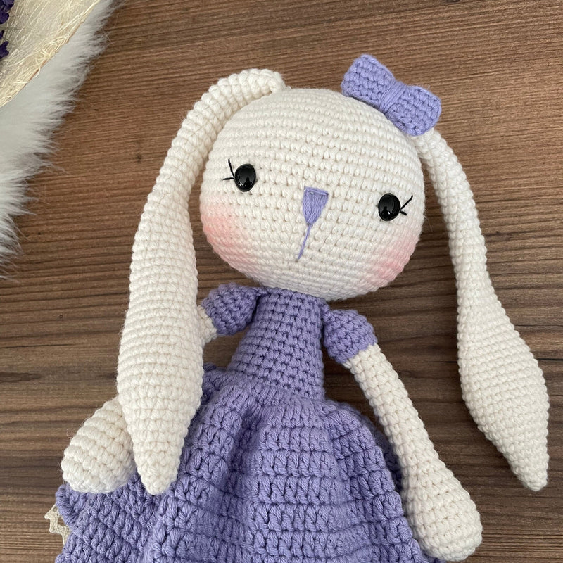 Handmade crochet Lilac Dressed Bunny Rabbit Toy, featuring long ears, a lilac dress with floral details, and personalized with a name on a leather label. Perfect for gifting.