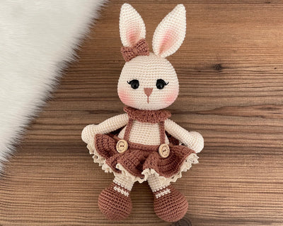 Handmade crocheted Chubby Girl Bunny Rabbit Toy with a cute dress and bow, customizable with a name on a leather label. Perfect for children and nursery decor.