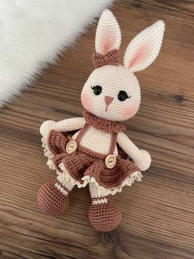 Handmade crocheted Chubby Girl Bunny Rabbit Toy with a cute dress and bow, customizable with a name on a leather label. Perfect for children and nursery decor.