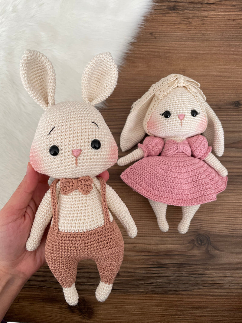 Handmade pink and brown bunny rabbit couple toy, crocheted with amigurumi technique, personalized with names on leather labels, perfect for gifts and decor.