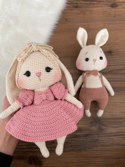 Handmade pink and brown bunny rabbit couple toy, crocheted with amigurumi technique, personalized with names on leather labels, perfect for gifts and decor.