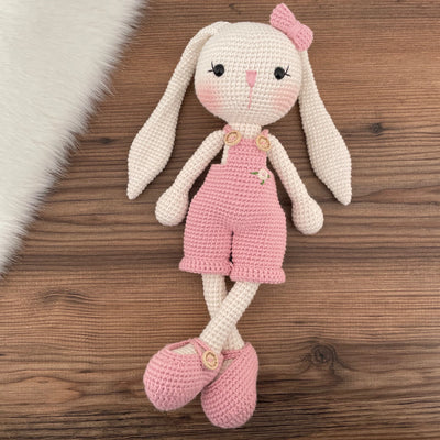 Handmade crochet Pink Overall Bunny Rabbit Toy, featuring long ears, a pink overall with floral details.