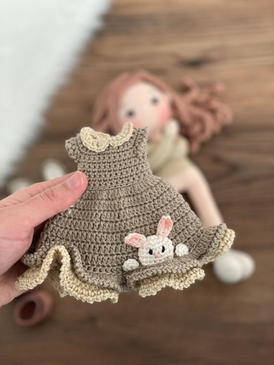 Handmade Bunny Girl Doll with bunny ears, wearing a khaki green dress with bunny details, made with 100% cotton yarn, customizable with a name on a leather label.