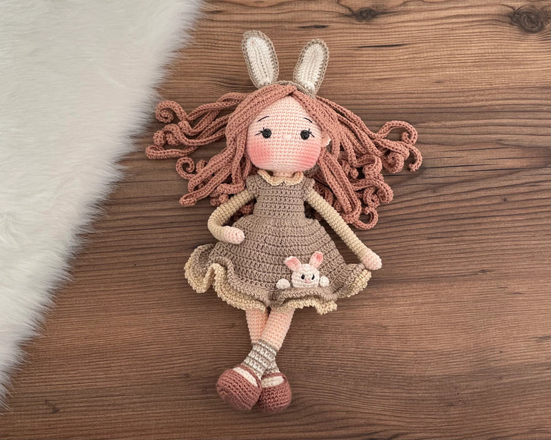 Handmade Khaki Green Bunny Girl Doll with bunny ears, wearing a khaki green dress with bunny details, made with 100% cotton yarn, customizable with a name on a leather label, perfect for unique girl gifts and imaginative play.