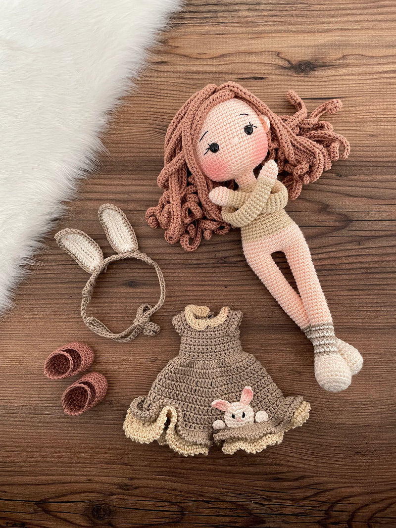 Handmade Bunny Girl Doll with bunny ears, wearing a khaki green dress with bunny details, made with 100% cotton yarn, customizable with a name on a leather label.