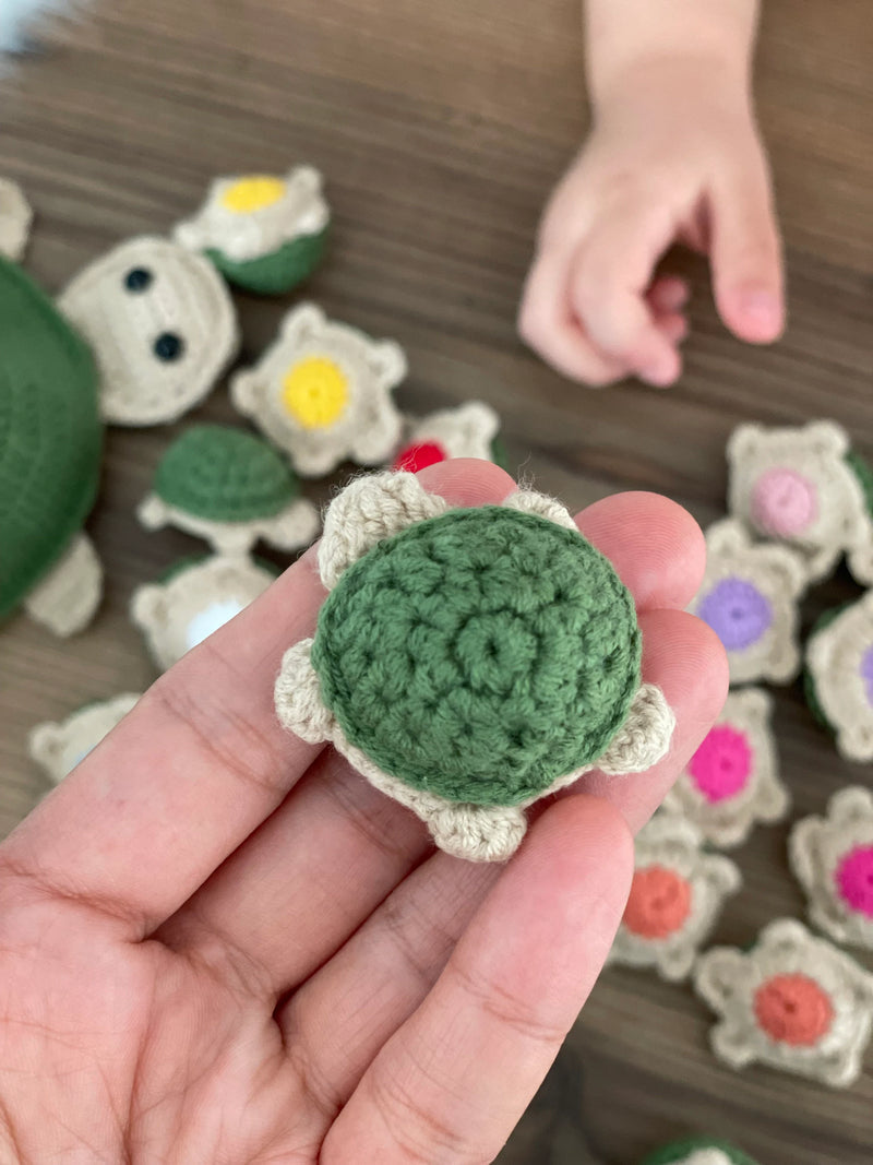 Handmade crochet turtle matching colors toy and memory game set. Includes a large turtle and small color-matching pieces for educational play. Customizable with a name on a leather label.