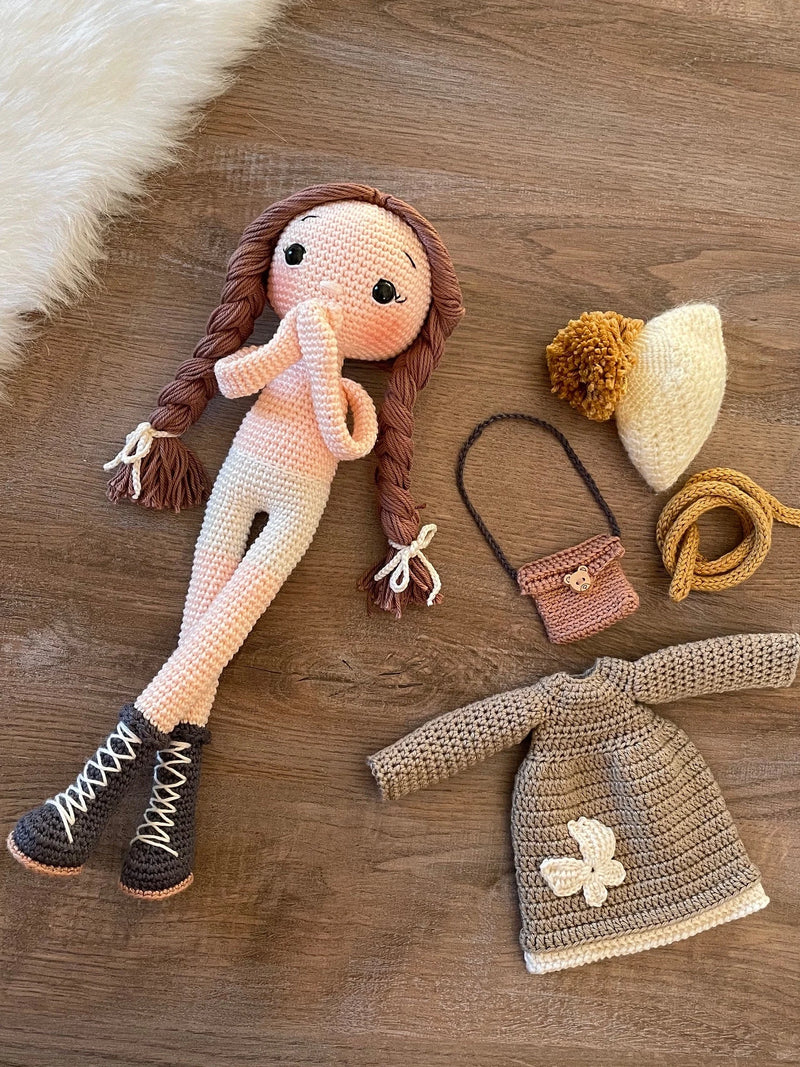 Handmade crochet Khaki Green Winter Girl Doll, featuring long braids, a cozy winter outfit, and personalized with a name on a leather label. Perfect gift for kids.