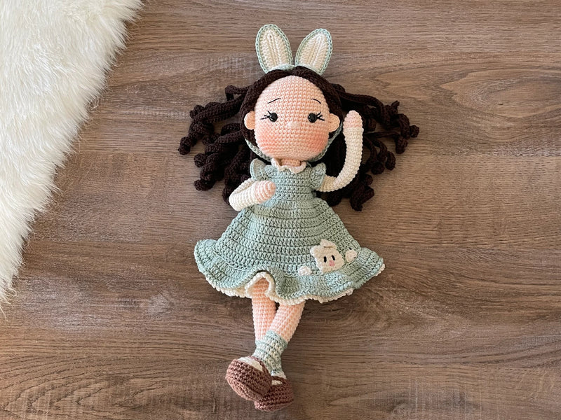 Handmade Mint Green Bunny Girl Doll with bunny ears, wearing a mint green dress with bunny details, made with 100% cotton yarn, customizable with a name on a leather label, perfect for unique girl gifts and imaginative play.